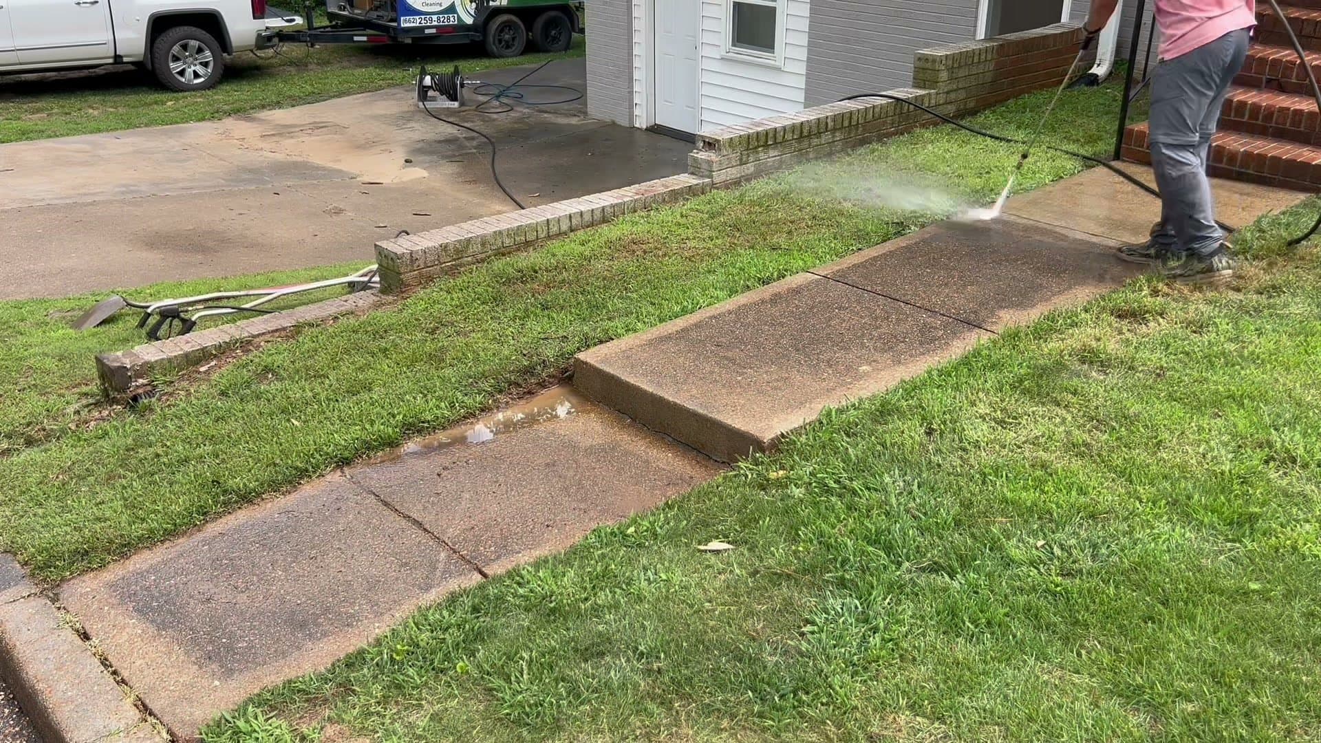 Brady of Can Man pressure washing a residential sidewalk in Oxford, Mississippi